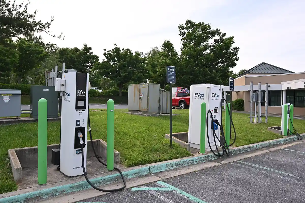 EVgo DC fast charging dispensers on a grassy island at a shopping center parking lot in Maryland