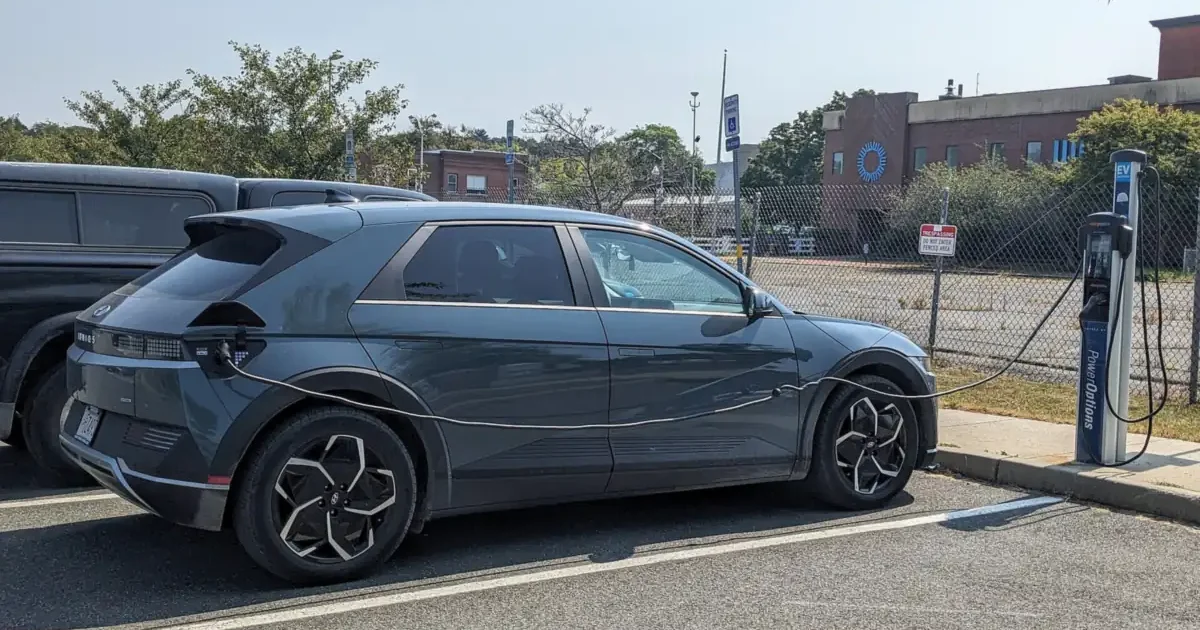 Gray Hyundai Ioniq 5 charging at a public ChargePoint Level 2 station in a municipal parking lot