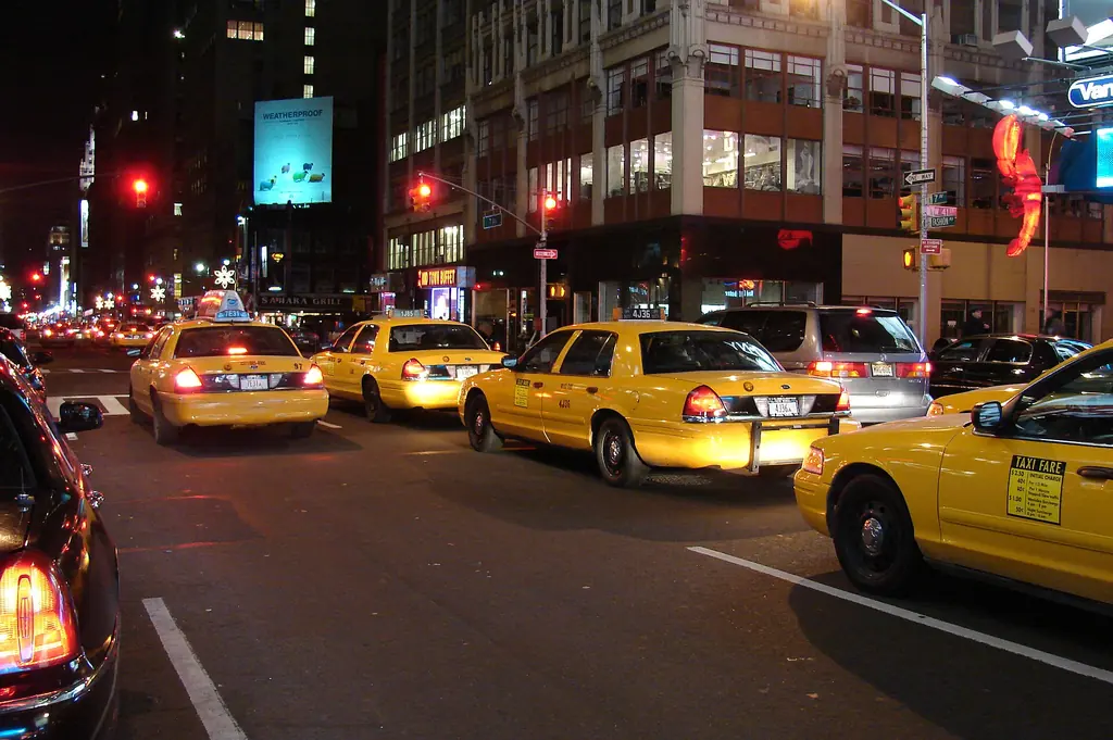 Yellow taxicabs at night in Manhattan, New York City; New York ranked third in 2023 average auto insurance expenditure (CC BY-SA 3.0, Wikimedia Commons)
