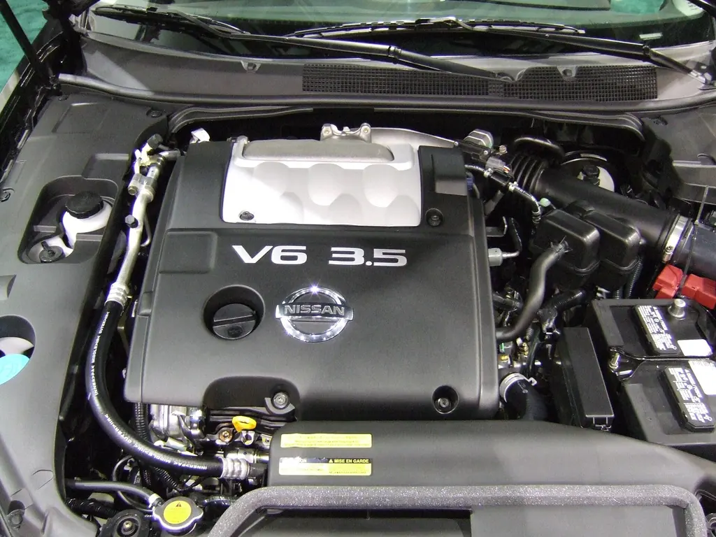 Nissan VQ35DE 3.5-liter V6 engine bay of a 2007 Nissan Maxima at an auto show, with the V6 3.5 engine cover