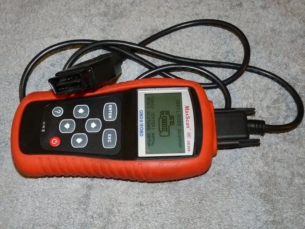 Handheld MaxScan OE509 OBD-II scanner with its OBD-II connector cable