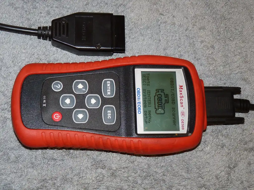 Handheld OBD-II scanner with its OBD-II connector cable