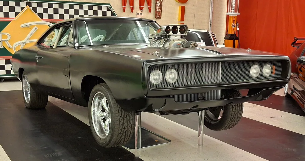 Black 1970 Dodge Charger R/T with a hood-mounted supercharger, described on Wikimedia Commons as a screen-used Fast & Furious stunt car, at the Rodz & Bodz Movie Car Museum auction in 2025