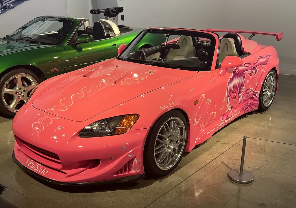 Pink 2001 Honda S2000 with anime-style airbrushed graphics, the car from 2 Fast 2 Furious, on display at the Petersen Automotive Museum in 2024