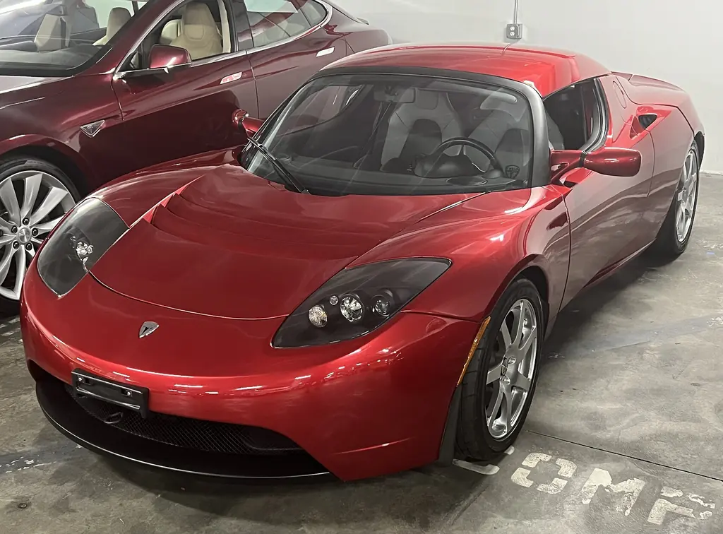Red first-generation Tesla Roadster with hardtop parked at the Petersen Automotive Museum