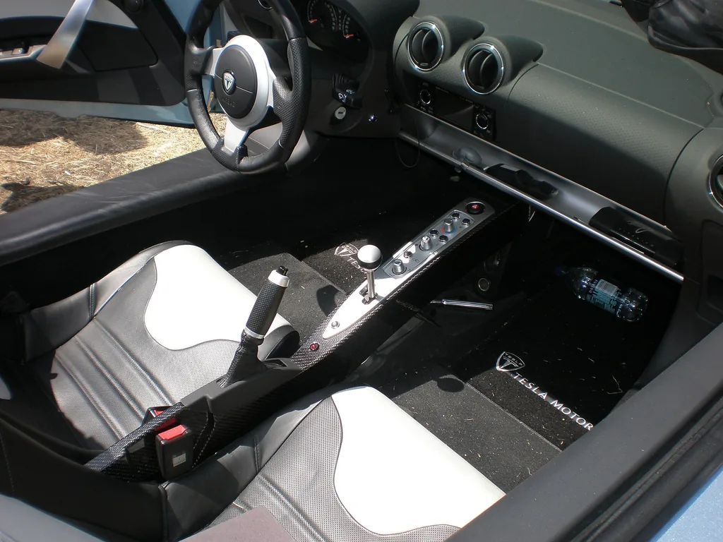 Interior of a first-generation Tesla Roadster showing the seats, steering wheel and center console