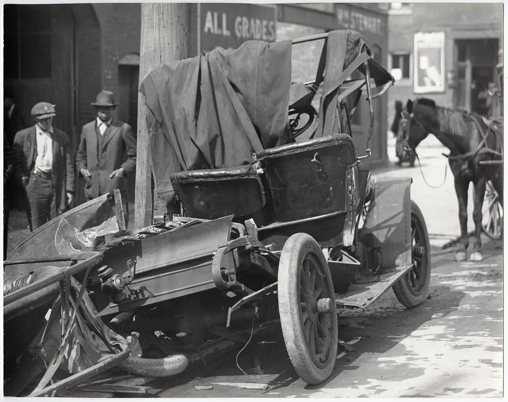 Historic photo of a wrecked automobile after a collision (Wikimedia Commons, public domain)